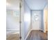 Hallway with wood flooring leads to rooms with carpet and has a backdoor with glass window at 3905 Kirksford Dr, Decatur, GA 30035