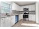 Modern kitchen features white cabinets, stainless steel appliances, and granite countertops at 3905 Kirksford Dr, Decatur, GA 30035