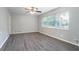 Bright living room features new wood floors, a ceiling fan, and a large window at 3905 Kirksford Dr, Decatur, GA 30035