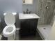 Bathroom featuring a modern vanity, granite countertop, and a tiled shower at 8317 Marlborough Dr, Jonesboro, GA 30238
