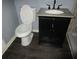 Bathroom with modern vanity, granite countertop, and dark-wood look flooring at 8317 Marlborough Dr, Jonesboro, GA 30238