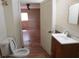 Bathroom with a view into the Primary bedroom with wood floors and tile surround at 8317 Marlborough Dr, Jonesboro, GA 30238
