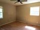 Bedroom with hardwood floors, neutral walls, and natural lighting from two windows at 8317 Marlborough Dr, Jonesboro, GA 30238