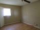 Neutral bedroom with laminate flooring, window, and a standard door to hallway or closet at 8317 Marlborough Dr, Jonesboro, GA 30238