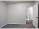 This bedroom has neutral walls, carpet, and an open door to the hallway at 2800 Macon Se Dr, Atlanta, GA 30354