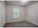 Cozy bedroom featuring neutral walls, plush carpet, and a window with natural light at 2800 Macon Se Dr, Atlanta, GA 30354