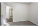 This bedroom features neutral walls, carpet, and an open door to the hallway at 2800 Macon Se Dr, Atlanta, GA 30354