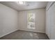 Bedroom featuring a window, plush carpet, and a closet with plenty of space at 2800 Macon Se Dr, Atlanta, GA 30354