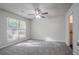 Bedroom featuring a ceiling fan, large window, and an open door to the hallway at 2800 Macon Se Dr, Atlanta, GA 30354