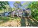 Inviting single-story home with manicured lawn, garden beds, and a cozy, welcoming exterior at 2800 Macon Se Dr, Atlanta, GA 30354