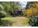 Backyard with green grass, flower bushes and a cozy house in the background at 2800 Memorial Se Dr, Atlanta, GA 30317