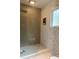 Modern bathroom with a glass-enclosed shower, neutral tile and decorative accent at 2800 Memorial Se Dr, Atlanta, GA 30317