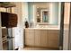 Bright bathroom featuring a double vanity, a large mirror and custom cabinet storage at 2800 Memorial Se Dr, Atlanta, GA 30317