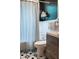 Updated bathroom with black and white tile floors, toilet, tub, and gray vanity at 2800 Memorial Se Dr, Atlanta, GA 30317