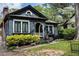 Beautiful dark-painted home with a brick chimney, complemented by vibrant landscaping and classic architecture at 2800 Memorial Se Dr, Atlanta, GA 30317