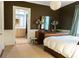 Comfortable bedroom with earth tones, a bright window, and connected bathroom at 2800 Memorial Se Dr, Atlanta, GA 30317