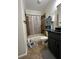 Bathroom with shower-tub combo, grey vanity, and neutral-toned tiling at 2964 Olivine Dr, Dacula, GA 30019