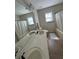 Bathroom with a double sink vanity, tile flooring, and a shower/tub combo with a curtain at 2964 Olivine Dr, Dacula, GA 30019