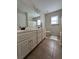 Bathroom with a double sink vanity, tile flooring, and a shower/tub combo with a curtain at 2964 Olivine Dr, Dacula, GA 30019