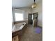 Bright bathroom with a soaking tub, tiled floors, and a glass-enclosed shower, creating a spa-like atmosphere at 2964 Olivine Dr, Dacula, GA 30019