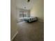 Bedroom featuring neutral carpet, a large window, and a bed with a striped comforter at 2964 Olivine Dr, Dacula, GA 30019
