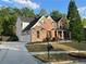 Beautiful two-story home boasts a brick and stone exterior, three-car garage, and a well-manicured lawn at 2964 Olivine Dr, Dacula, GA 30019
