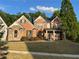 Charming brick two-story home with stone accents, landscaped yard, and covered front porch at 2964 Olivine Dr, Dacula, GA 30019