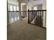 Hallway featuring decorative iron railing overlooking a fireplace and staircase below at 2964 Olivine Dr, Dacula, GA 30019