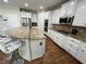 Close-up of the modern kitchen with white cabinetry, granite countertops, and a stylish island at 2964 Olivine Dr, Dacula, GA 30019