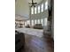 Bright living room with high ceilings, large windows, fireplace, and open layout to kitchen at 2964 Olivine Dr, Dacula, GA 30019