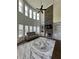 Spacious living room featuring soaring windows, stone fireplace, and modern sofa at 2964 Olivine Dr, Dacula, GA 30019