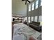Bright open-concept living room with soaring windows, modern furniture, and view into the kitchen at 2964 Olivine Dr, Dacula, GA 30019