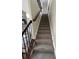 Carpeted staircase featuring stained wood banister and iron spindles leading to the upper level at 2964 Olivine Dr, Dacula, GA 30019