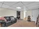 A finished basement with a black couch and decorative furnishings at 4917 Baker Ridge Pl, Acworth, GA 30101