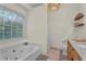 Bathroom with a large soaking tub and lots of natural light at 4917 Baker Ridge Pl, Acworth, GA 30101