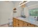 Bright bathroom featuring a large window and updated vanity at 4917 Baker Ridge Pl, Acworth, GA 30101