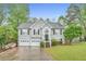 Charming two-story home with a well-manicured lawn, gray siding, and a two-car garage at 4917 Baker Ridge Pl, Acworth, GA 30101