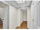 A hallway with white walls and doors and brown flooring at 4917 Baker Ridge Pl, Acworth, GA 30101