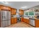 Well-equipped kitchen with stainless steel appliances, wooden cabinets, and a farmhouse sink at 4917 Baker Ridge Pl, Acworth, GA 30101