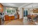 Open concept kitchen with stainless appliances, wooden cabinets, and an adjacent dining area at 4917 Baker Ridge Pl, Acworth, GA 30101