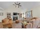 Comfortable living room with a fireplace, built-in shelving, vaulted ceilings, and neutral tones at 4917 Baker Ridge Pl, Acworth, GA 30101