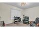 A bedroom with a wooden desk and chair, a leather recliner and blinds in the window at 4917 Baker Ridge Pl, Acworth, GA 30101