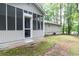 Backyard with mature trees, a screened-in porch, and tranquil setting at 5819 Stonehaven Nw Dr, Kennesaw, GA 30152