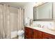 Bathroom with granite vanity, framed mirror, and shower with patterned curtain at 5819 Stonehaven Nw Dr, Kennesaw, GA 30152