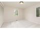 Neutral bedroom featuring carpet, fresh paint, and windows overlooking the yard at 5819 Stonehaven Nw Dr, Kennesaw, GA 30152