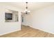 Bright dining room with wood-look floors, chandelier, and convenient kitchen access at 5819 Stonehaven Nw Dr, Kennesaw, GA 30152