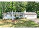 Charming ranch-style home with a well-manicured lawn and mature trees provides a picturesque setting at 5819 Stonehaven Nw Dr, Kennesaw, GA 30152