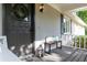 Charming front porch with wreath, bench, and ambient lantern at 5819 Stonehaven Nw Dr, Kennesaw, GA 30152