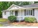 Charming front porch with seating area and neatly landscaped shrubbery, offering curb appeal at 5819 Stonehaven Nw Dr, Kennesaw, GA 30152