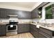 Well-equipped kitchen featuring granite countertops, stainless steel appliances and stylish cabinetry at 5819 Stonehaven Nw Dr, Kennesaw, GA 30152